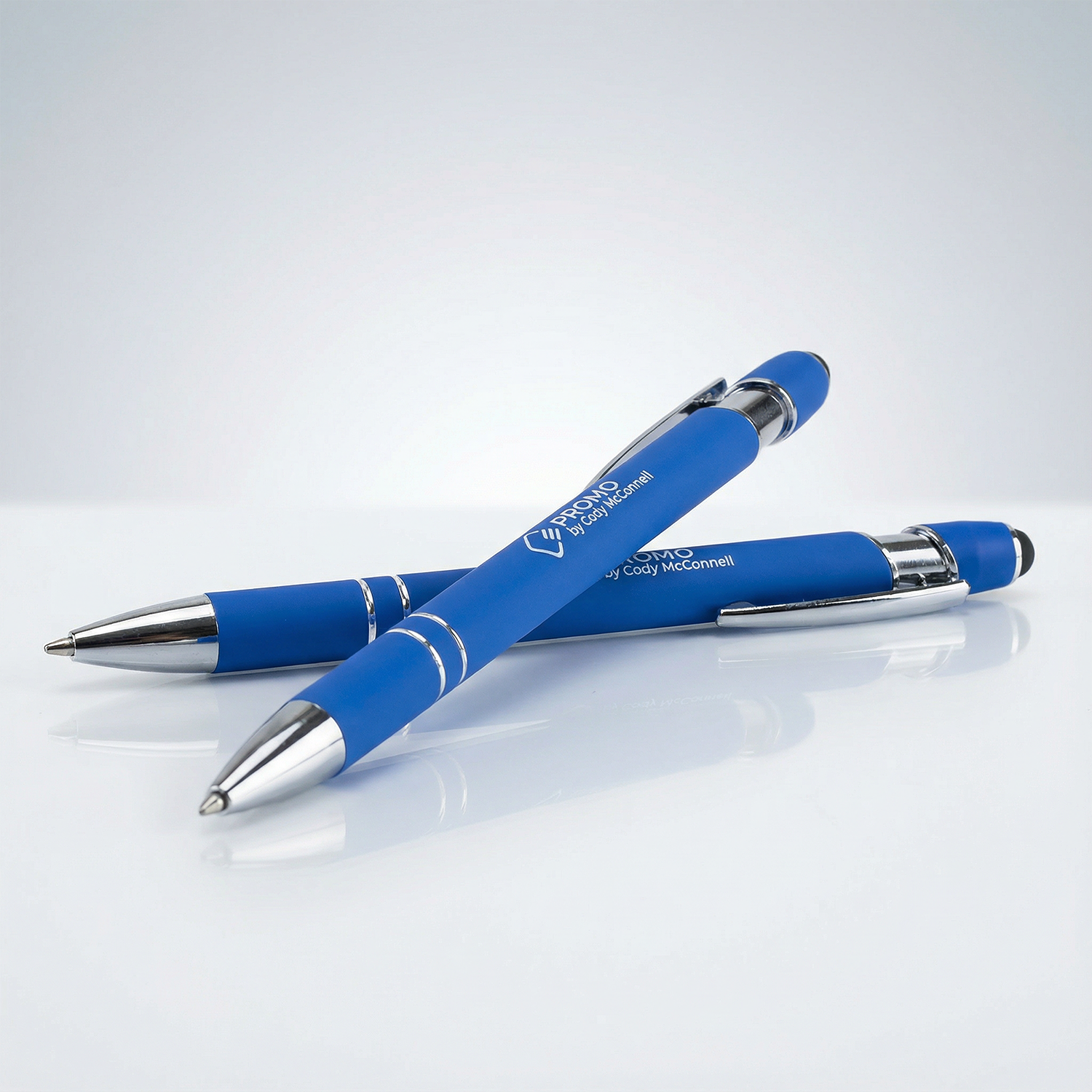 Two blue pens with silver accents on a white background