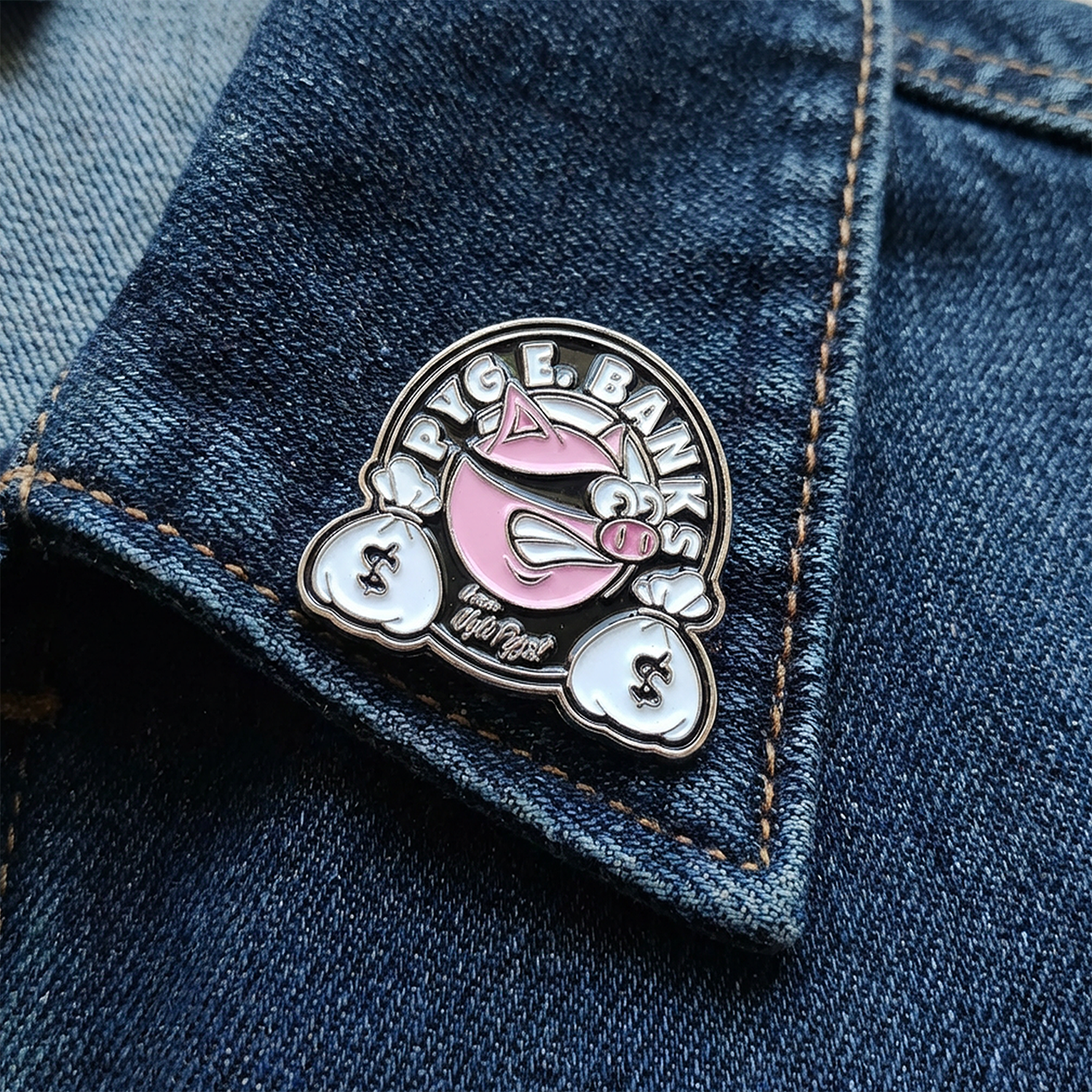Enamel pin with a pink and silver design on a denim jacket