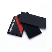 "Custom PVC Velcro patch with a bold '¡NO PASARÁN!' logo design in black and red, featuring hook-and-loop backing for easy attachment, displayed on a white background.