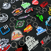 bulk custom keychains on black background, different business logos